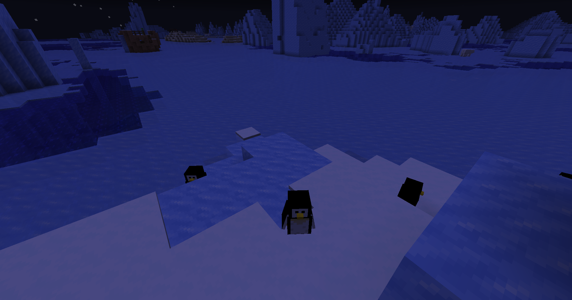 Minecraft icy biome screenshot showing penguins on the snow near frozen water at night.